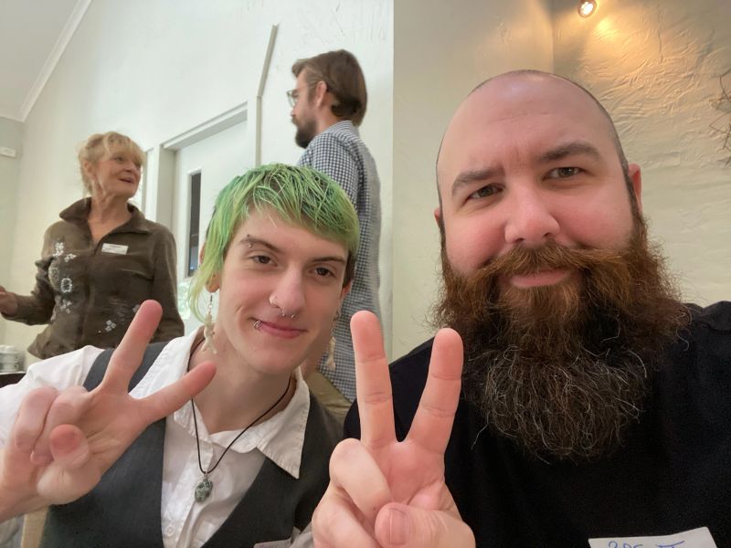 Two people peace signing the camera.